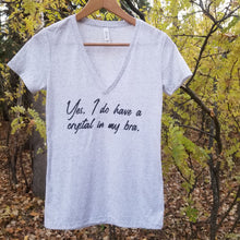 Load image into Gallery viewer, white tshirt hanging in a tree with the words Yes, I do have a crystal in my bra. written on it