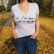 Load image into Gallery viewer, A female model standing in a forest wearing a white tshirt that says, Yes I do have a crystal in my bra