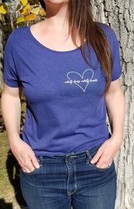 Image of "Wholly loving, wholly lovable" t-shirt on model with front of tee tucked into jeans.