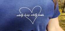 Load image into Gallery viewer, A close-up of the heart design for the &quot;Wholly loving, wholly lovable&quot; t-shirt.
